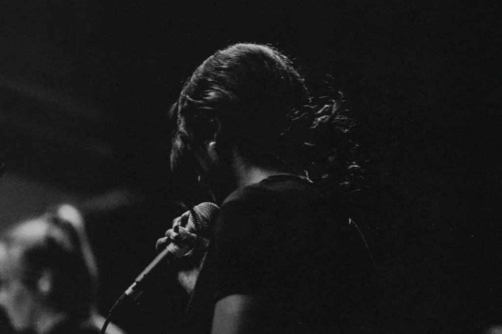 Woman holding a microphone worshipping