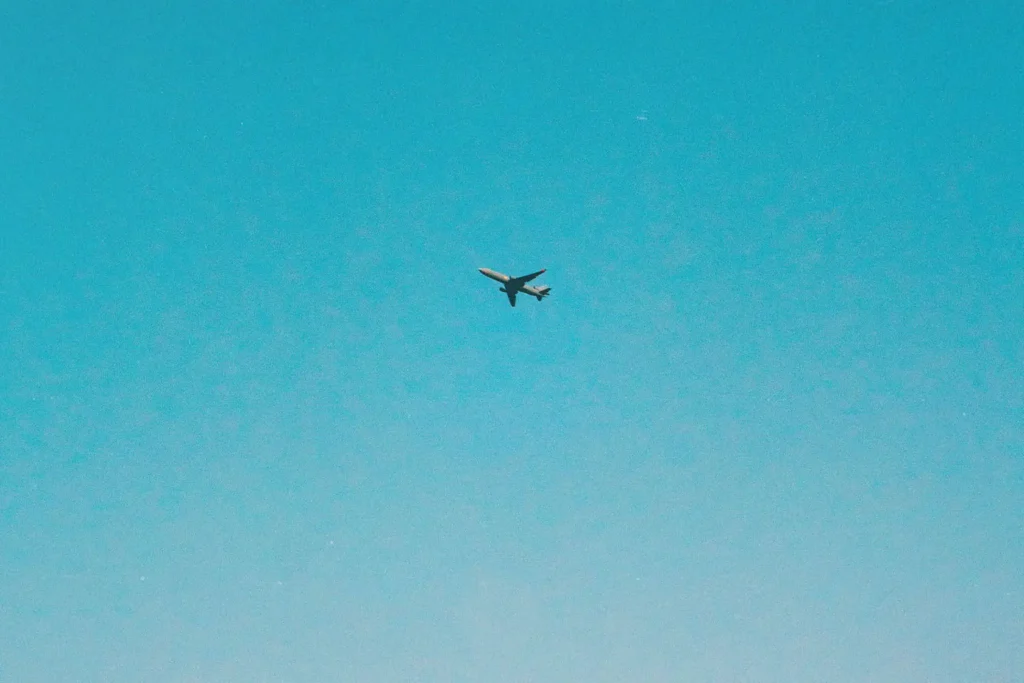 Airplane flying through blue sky