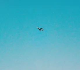 Airplane flying through blue sky