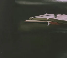 An open Bible and notebook on a table