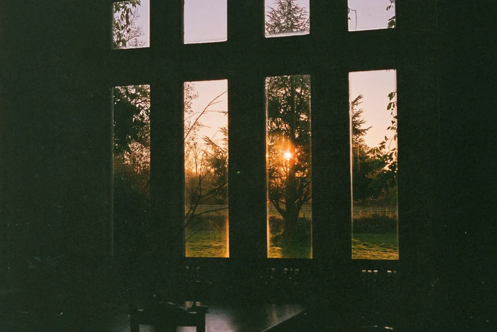 View of sunset on the horizon through a window