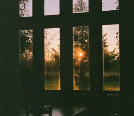 View of sunset on the horizon through a window