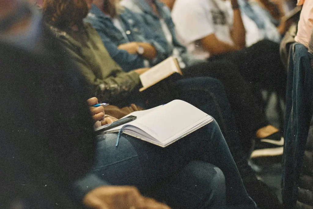 Line of people with open Bibles resting on their laps