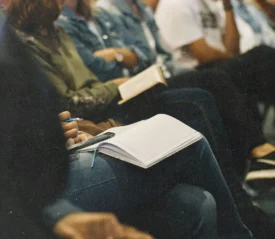 Line of people with open Bibles resting on their laps