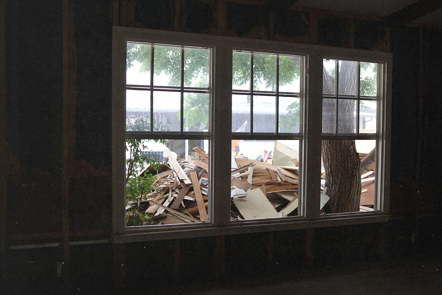 Open windows with a pile of construction scraps outside
