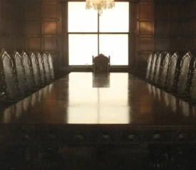 Board room with empty table and chairs