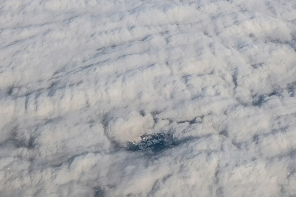 Shot of clouds from above with small town peeking through