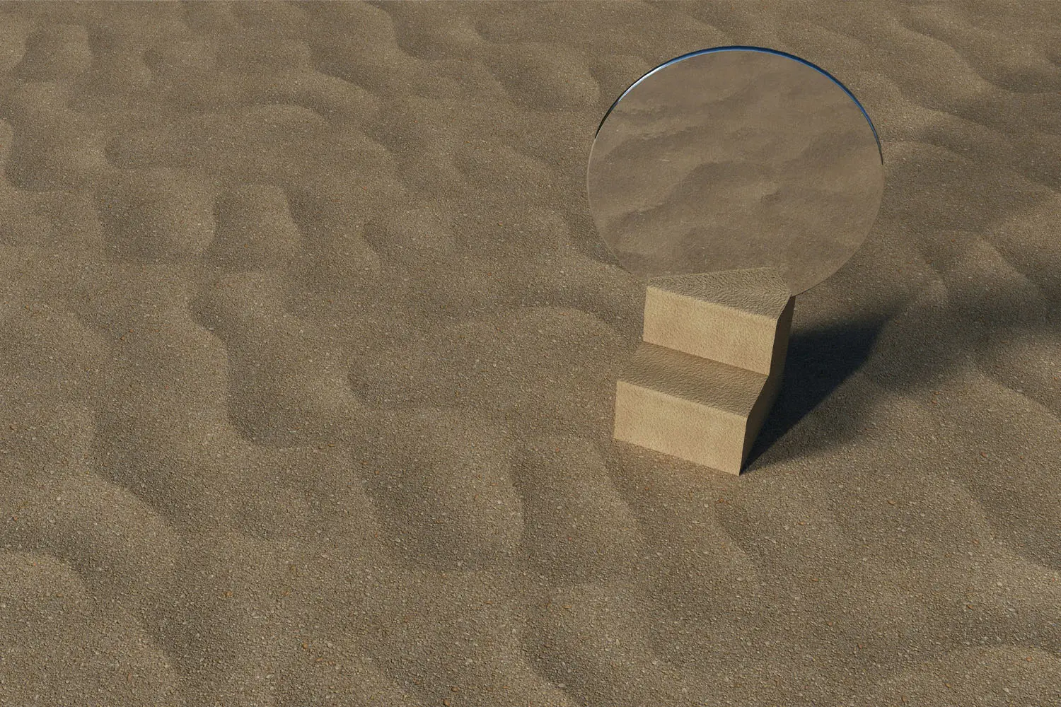 Round mirror placed on a small wooden block in the middle of textured sand, reflecting the surrounding sandy surface