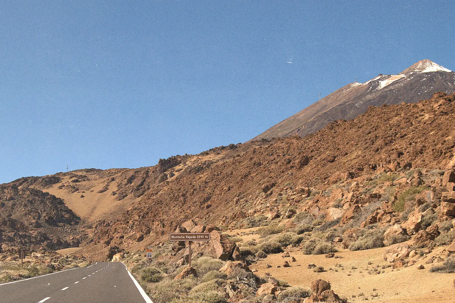 side of a rock mountain with a hint of the road