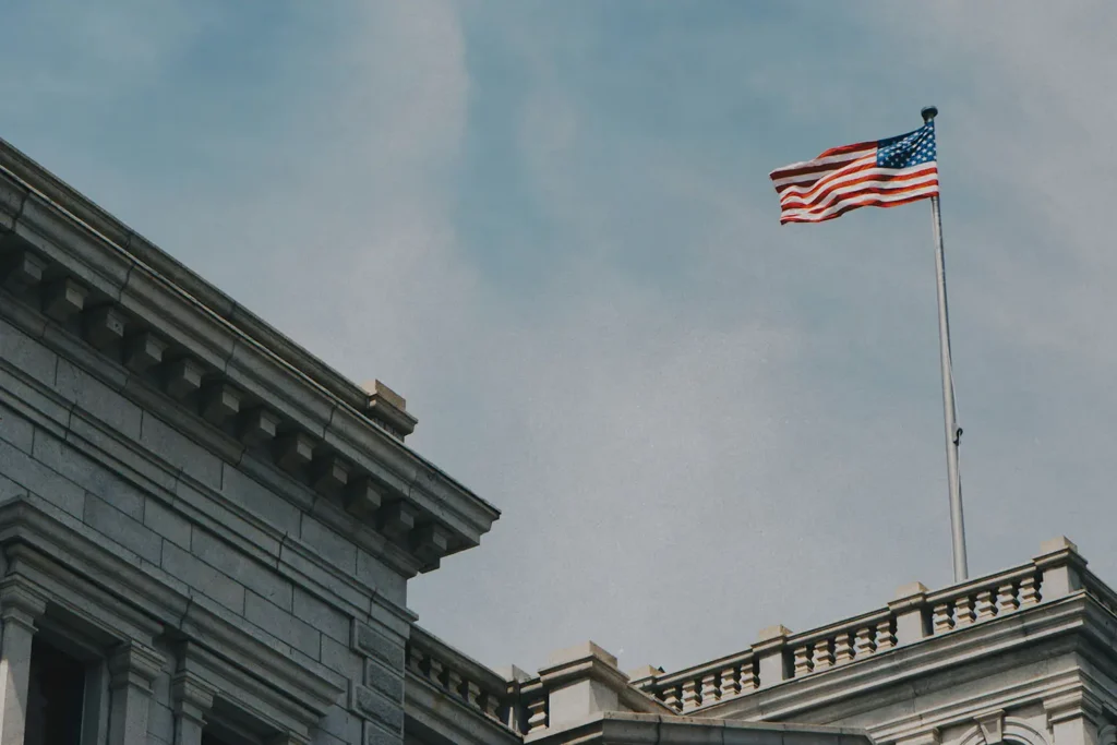 flag flying on top of a white building