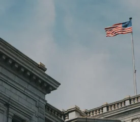 flag flying on top of a white building