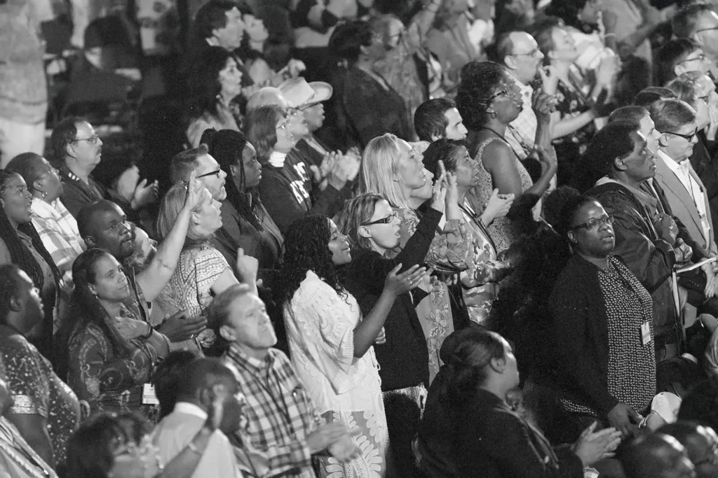 black and white photo of people praising