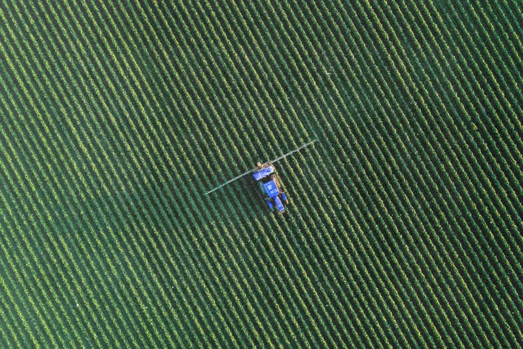 Aerial view of combine harvester in open field