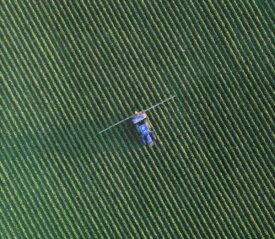 Aerial view of combine harvester in open field