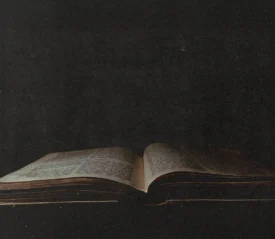 dark photo of open bible in a low light