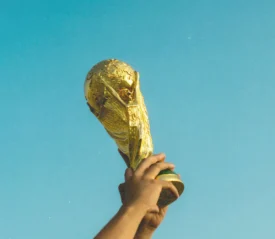 person holding up a trophy to the sky