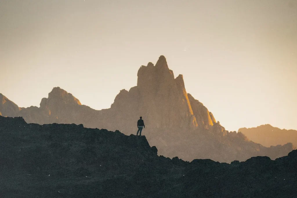 person standing on a top a mountain