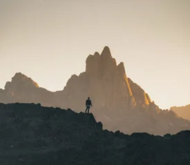 person standing on a top a mountain