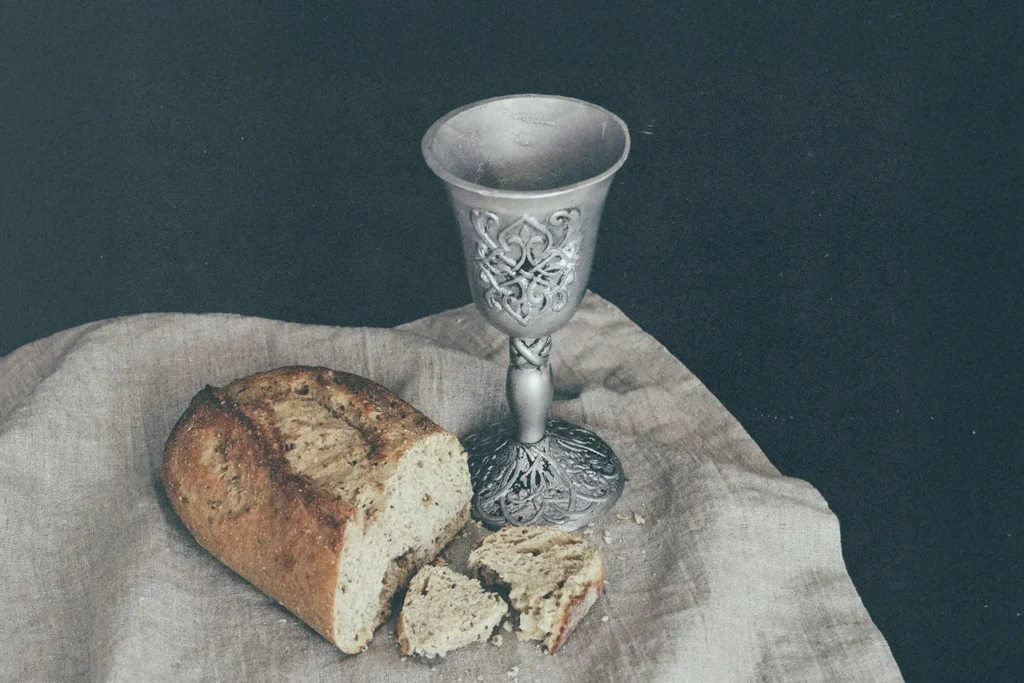 bread and goblet on napkin on a table
