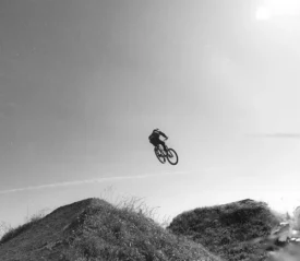 mountain biker jumping a hill