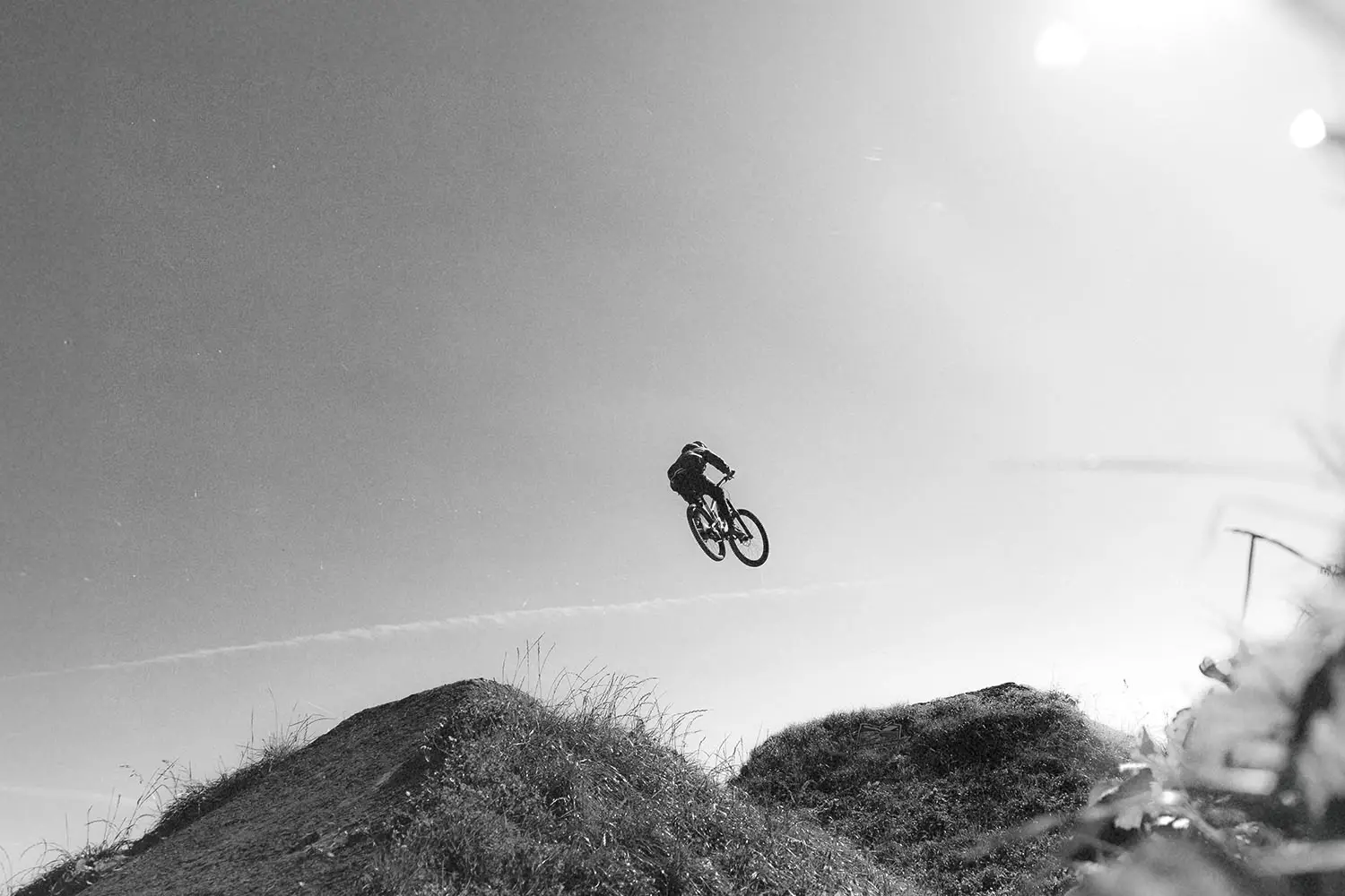 mountain biker jumping a hill