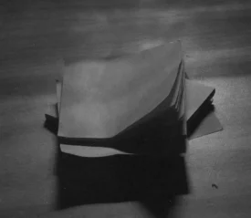 Stack of papers on a wooden table