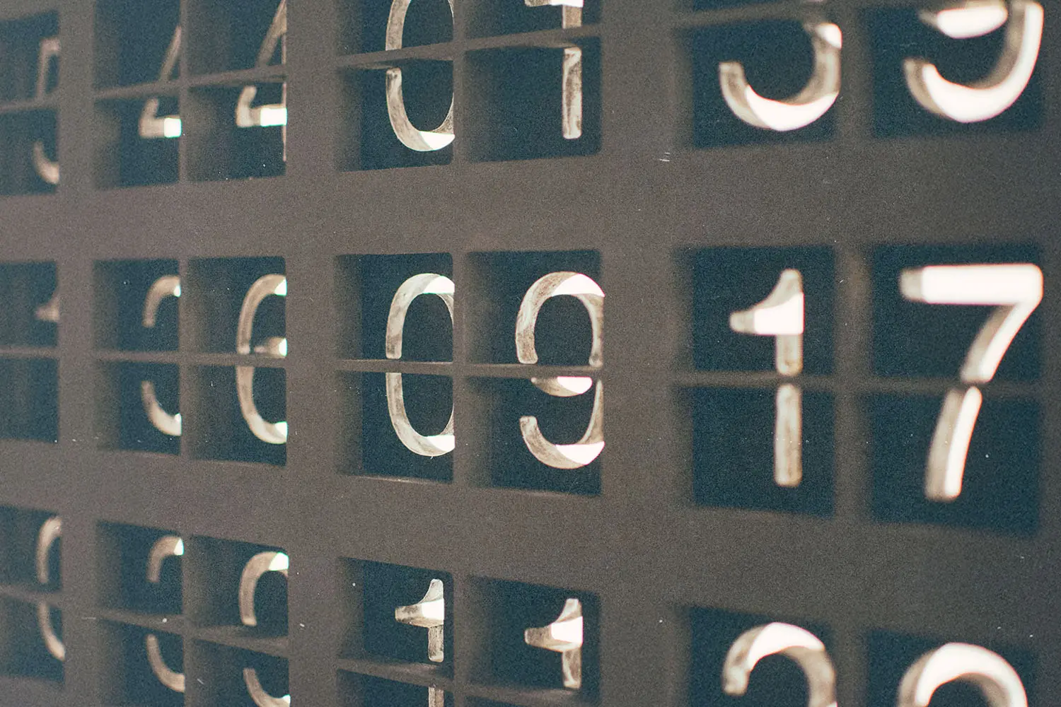 Close-up of illuminated numbers arranged in a grid, with the number seventeen clearly visible among other digits