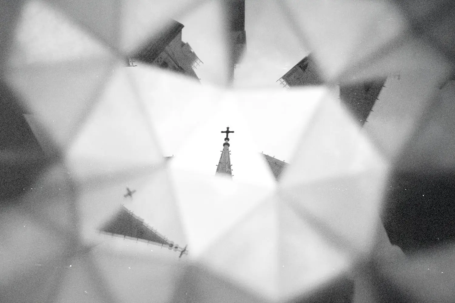 Church steeple with a cross reflected multiple times in a kaleidoscope‑style pattern