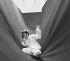 girl sliding through fabric curved like a slide