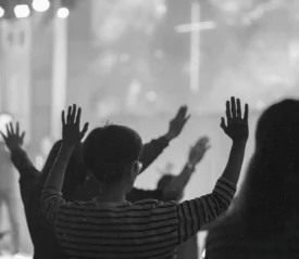 people raising their hands in prayer