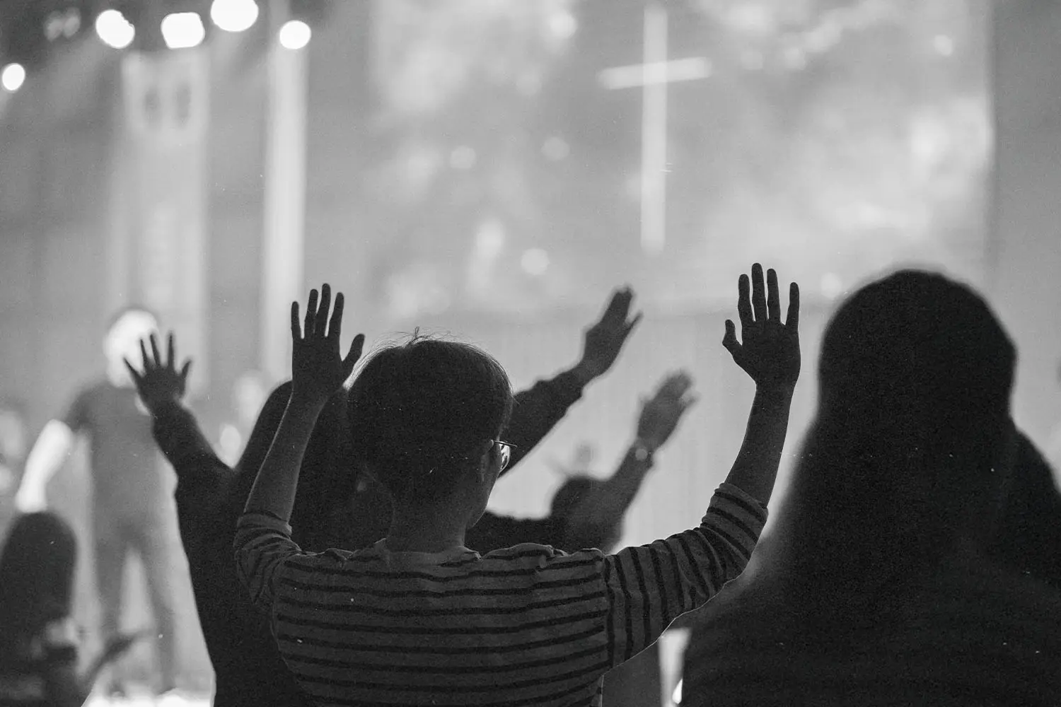 people raising their hands in prayer