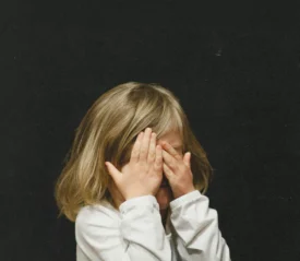 toddler covering her eyes