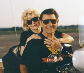 Kenneth and Gloria Copeland hugging on a motorcycle