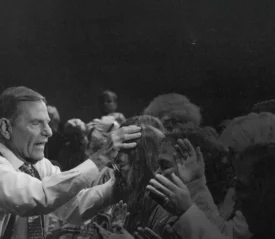 Kenneth Copeland praying over people