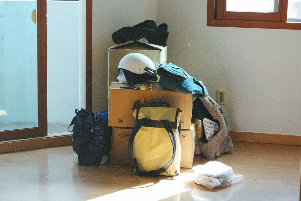 Pile of stuff covering boxes in the corner of an empty room