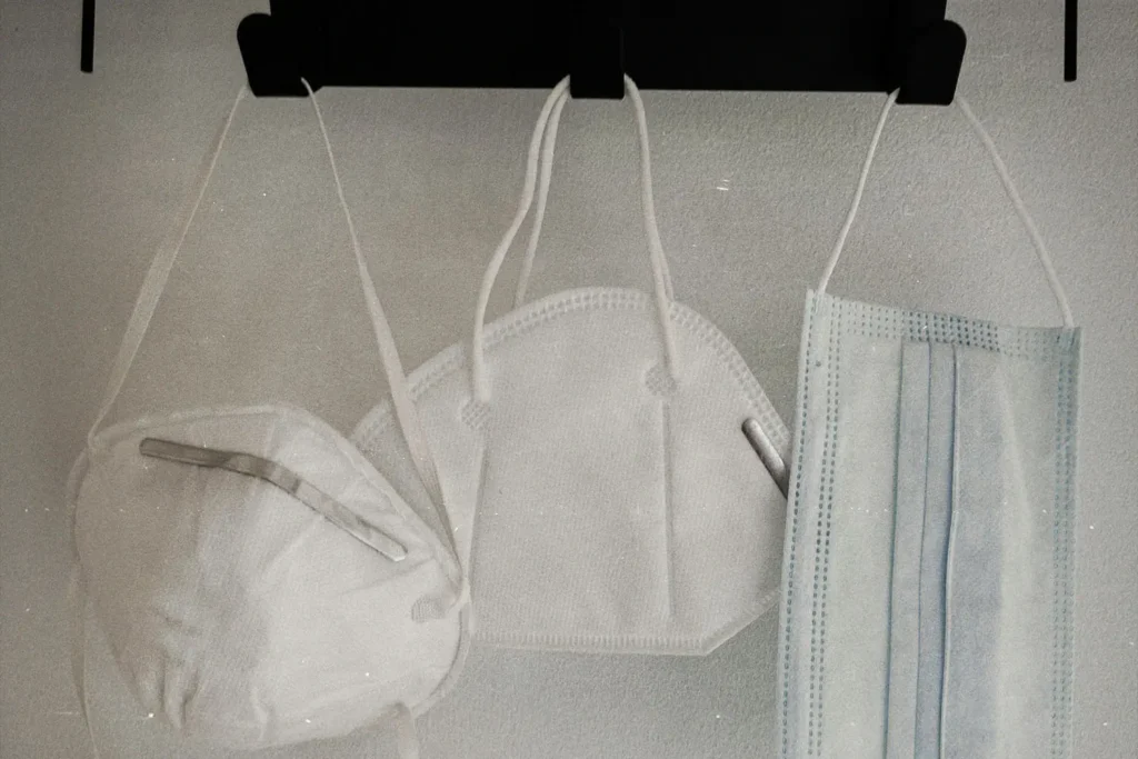 three hanging face masks