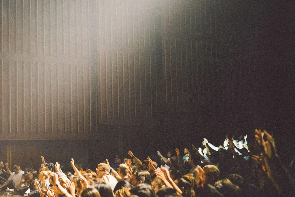 group of people praising with raised hands