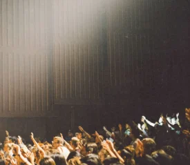 group of people praising with raised hands