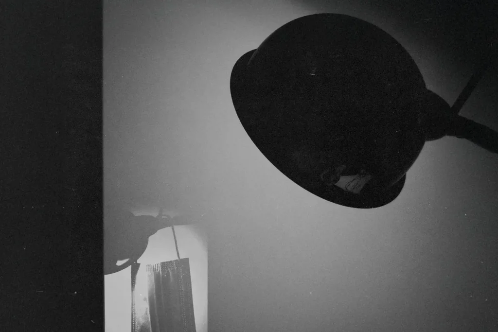 harsh spotlight luminates a paper face mask