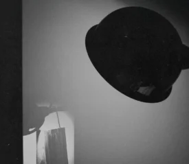 harsh spotlight luminates a paper face mask