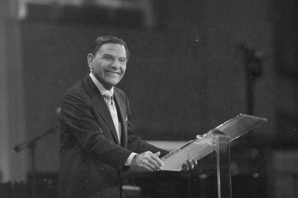 Kenneth Copeland smiling at a podium