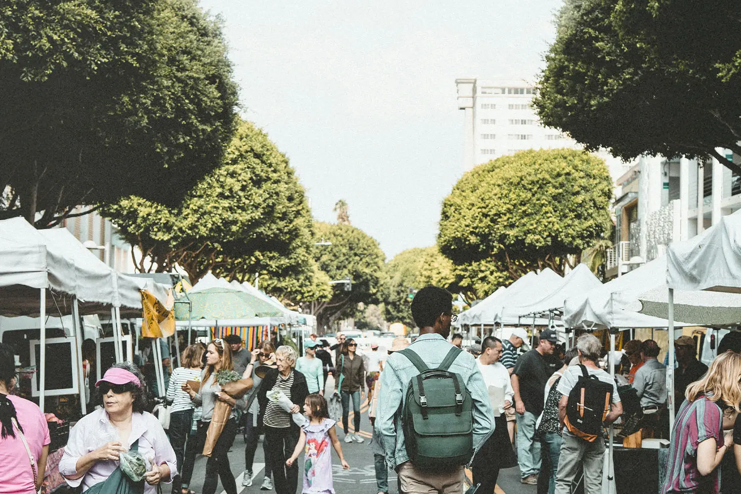 Person walking through crowded street market