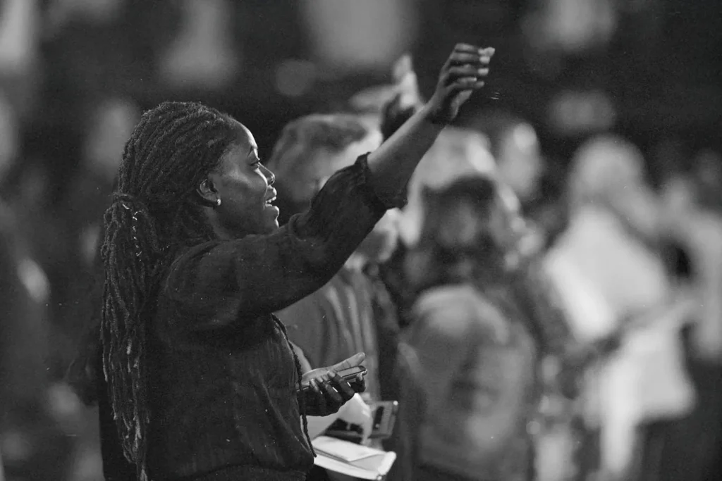 Woman standing with her hands lifted in praise