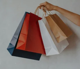 Hand holding multiple shopping bags