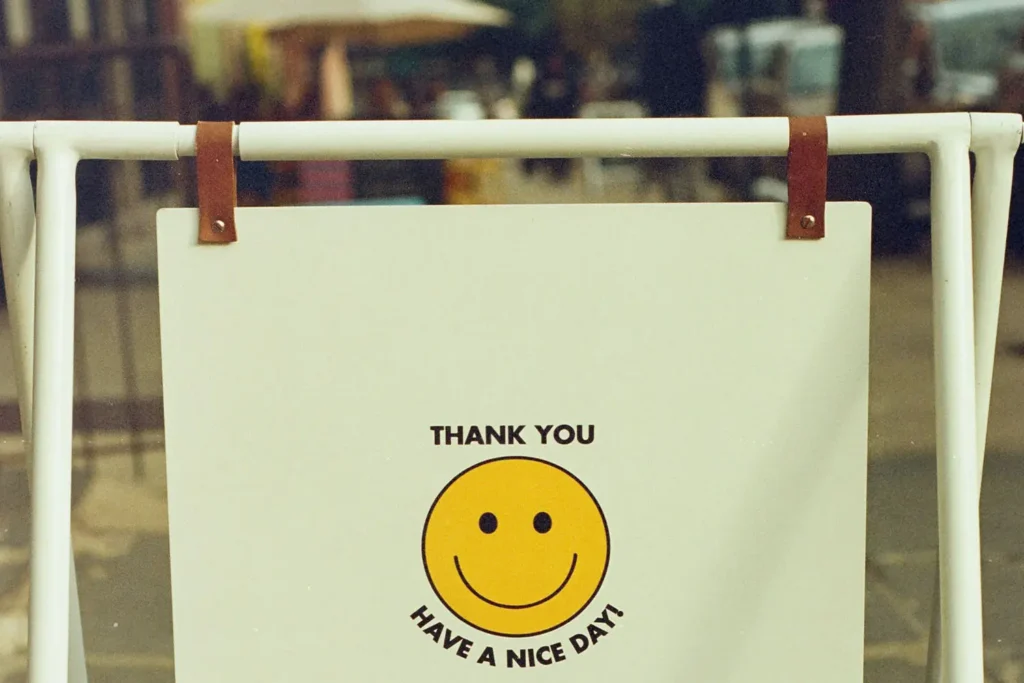 Hanging sign that reads "THANK YOU HAVE A NICE DAY!" with a yellow smiley face