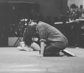 Person on their hands and knees praying