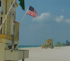 Lifeguard stand on the beach with an American flag flying