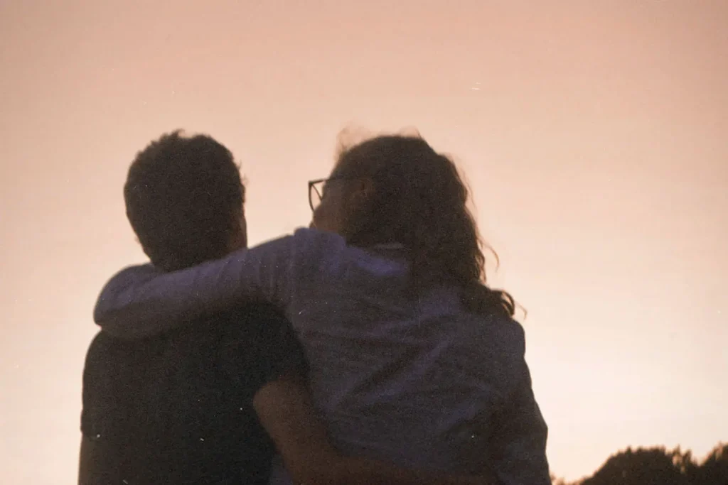 A couple with arms around each other