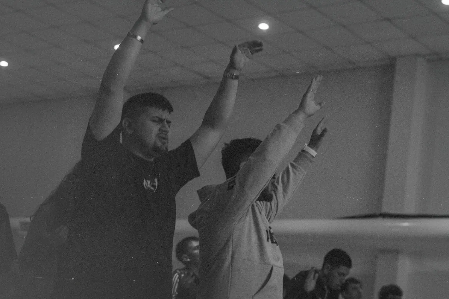 Two men lifting their hands in prayer
