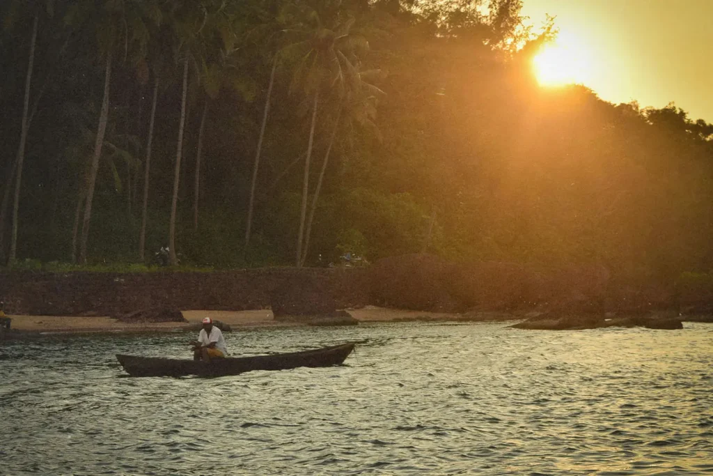 Man in a kayak on a lake with trees in the background